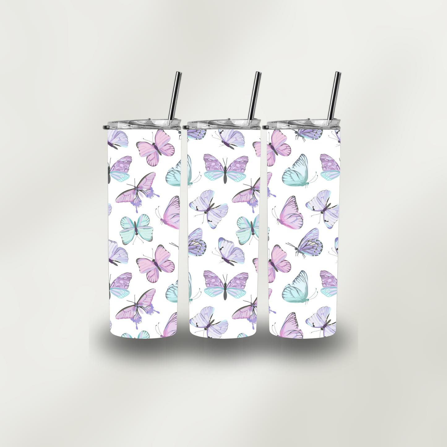 Three tumblers with butterfly pattern on a white background