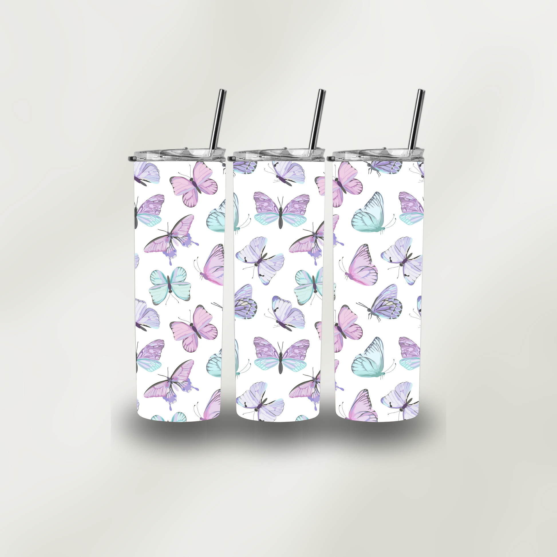 Three tumblers with butterfly pattern on a white background